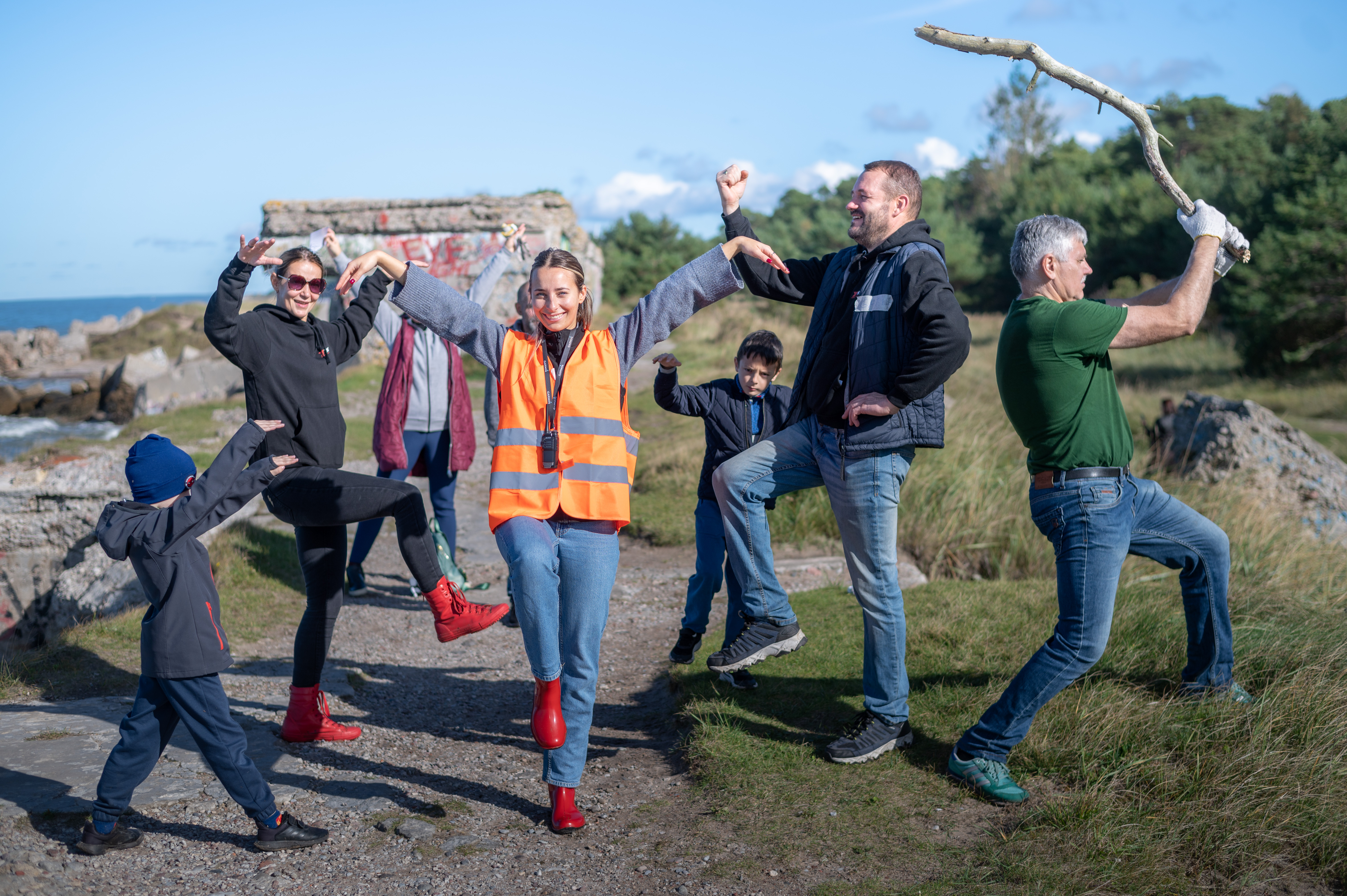 A group taking part in an outdoor team challenge on a rocky coast